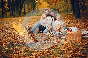 Family with cute kids in a autumn park