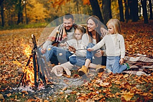 Family with cute kids in a autumn park