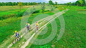 Family cycling on bikes outdoors aerial view from above, active mother with children have fun, family sport and fitness