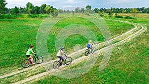 Family cycling on bikes outdoors aerial view from above, happy active mother with children have fun