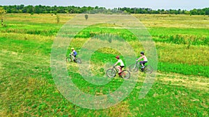 Family cycling on bikes outdoors aerial view from above, happy active mother with children have fun