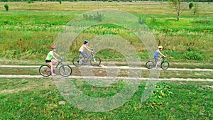 Family cycling on bikes outdoors aerial view from above, happy active mother with children have fun, family sport