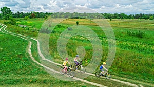 Family cycling on bikes outdoors aerial view from above, happy active mother with children have fun, family sport