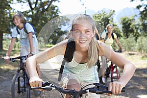 Family Cycling Through Countryside