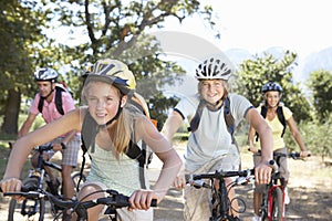 Family Cycling Through Countryside