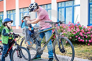 Family cycling, father with happy kid riding bike outdoors