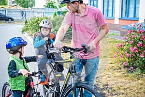 Family cycling, father with happy kid riding bike outdoors