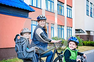 Family cycling, father with happy kid riding bike outdoors