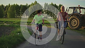 Family cycling in nature. Woman and teenage boy riding bicycles