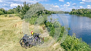 Family cycling outdoors, bicycles near river, aerial view of bikes and helmets from above, sport and fitness