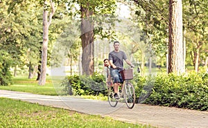 Family cycling outdoors - family on bicycles in park
