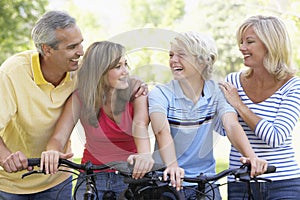 Family Cycling Through A Park