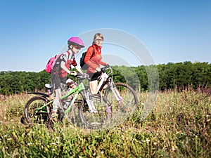 Family cycling in summer