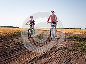 Family cycling in summer