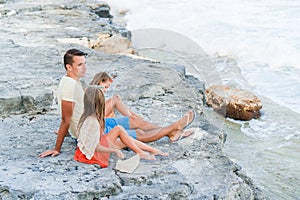 Family of dad and kids ejoy summer vacation on caribbean island.