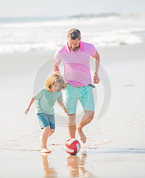 family of daddy man and child boy playing ball on beach together, football