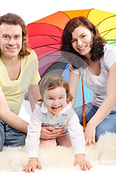 Family daughter are sitting under umbrella