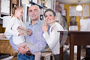 Family with daughter in specialised furniture showroom photo