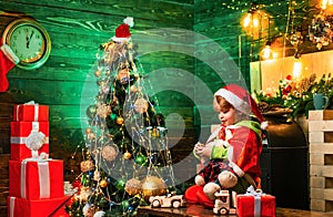 Family day christmas. Gifts and surprises. Cute little child boy play near christmas tree. Merry christmas and happy new