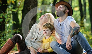 Family day concept. Happy family with kid boy relaxing while hiking in forest. Family weekend. Mother father and little