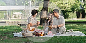 Family day, family picnic together at the park. Retired grandparent take granddaughter to relax and spend time together