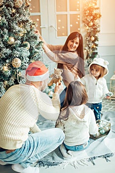 Family decorating a Christmas tree
