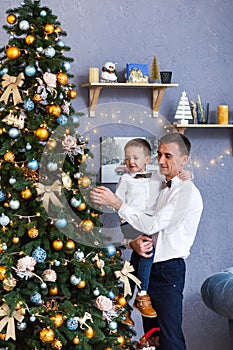 Family decorating a Christmas tree at home