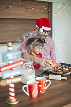 Family decorating gingerbread cookies