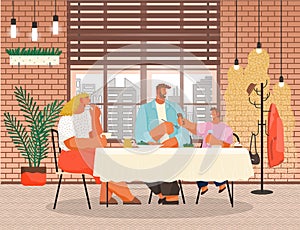 Family members smiling mother, father and son sitting together at a table in a restaurant and eating