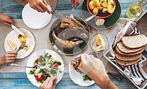 Family dinner with fried fish, potato and salad