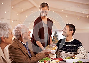 Family, dinner and smile at table on Christmas, together with food and celebration in home. Senior, mother and father