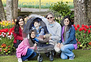 Family with disabled boy in the tulips gardens