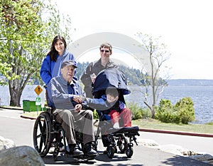 Family with disabled senior and child outdoors