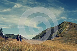 Family discuss about itinerary on the top of mountain hil