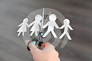 Family divorce concept with human paper shapes and scissors