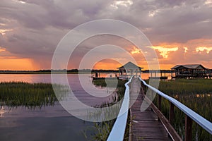 Family on dock at sunset