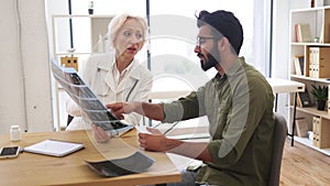 Family doctor examining diagnostic test results while developing treatment plan.