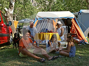 Family with dog at a camp