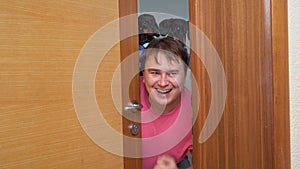 Family with dog peeking out door celebrating victory, gesture of luck tomfoolery