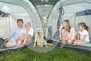 Family with dog in tent