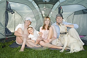 Family with dog in tent