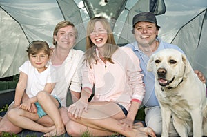 Family with dog in tent