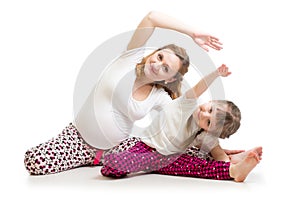 Family doing gymnastics. Pregnant woman with daughter exercising stretching on floor