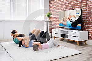 Family Doing Home Online Fitness Exercise