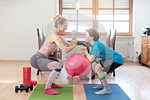 Family doing squats on floor at home during Covid-19 curfew