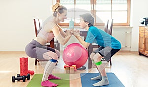 Family doing squats on floor at home during Covid 19 curfew