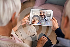 Family doing video call using digital tablet at home