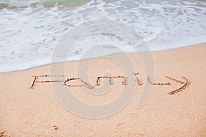 Family drawing in the sand on a tropical beach