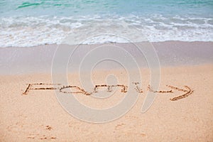 Family drawing in the sand on a tropical beach