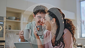 Family drinking coffee tablet sitting kitchen close up. Happy couple laughing